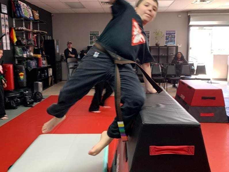 student doing kicks for self defense for kids