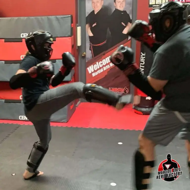 Teen martial arts student practicing controlled punches with a training partner while wearing protective gear during self-defense drills, teens self-defense awareness.