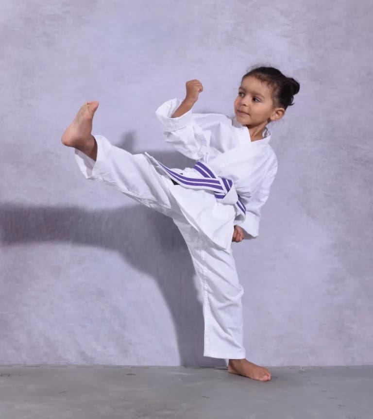 toddler practicing kicks for preschool self defense lessons