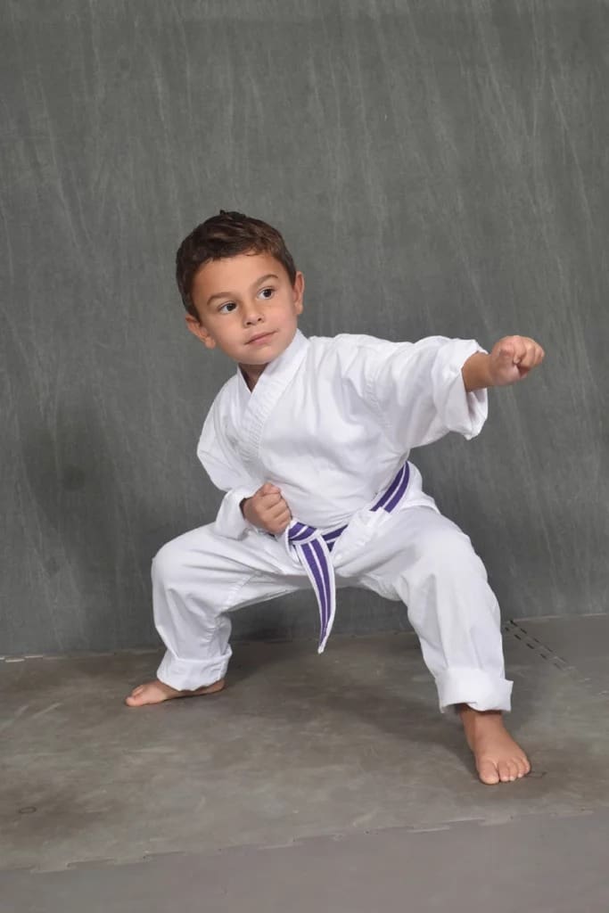 child practicing punches for preschool self defense class