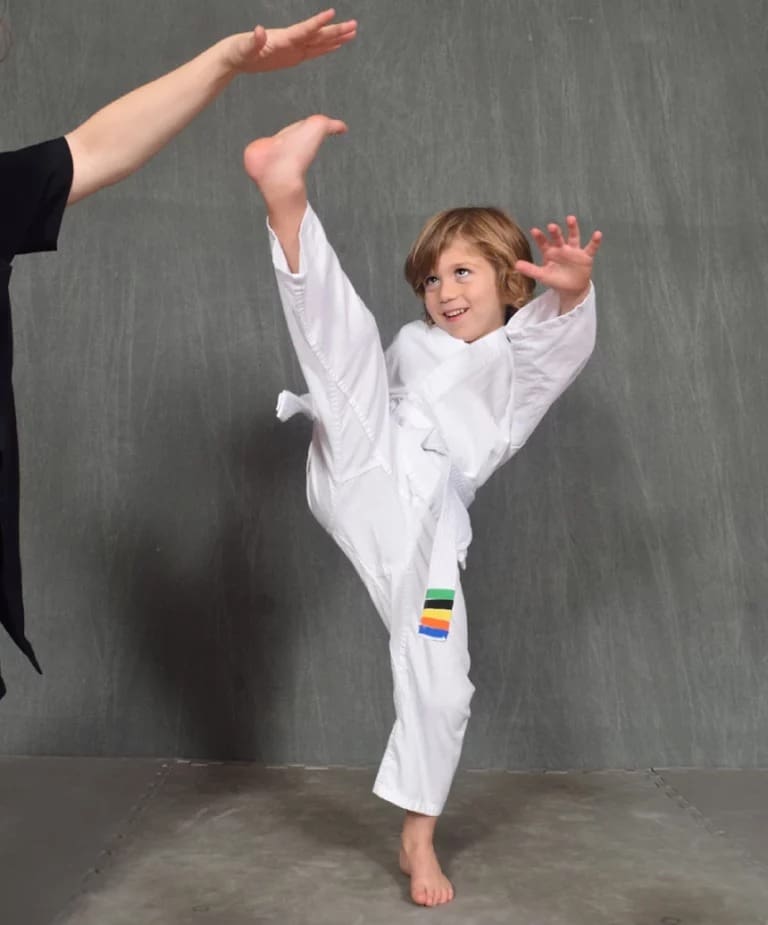 student practicing high kicks for preschool self defense class